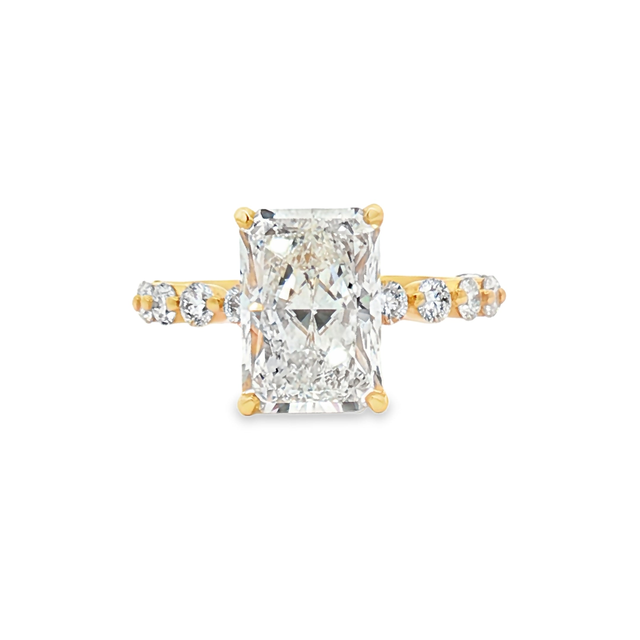 alt="front view of lab grown radiant cut diamond engagement ring with accented band and hidden halo in 14K yellow gold"