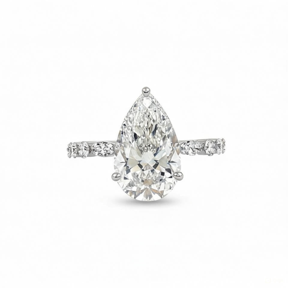 alt="front view of lab grown pear cut diamond engagement ring with accent band in 14K white gold"