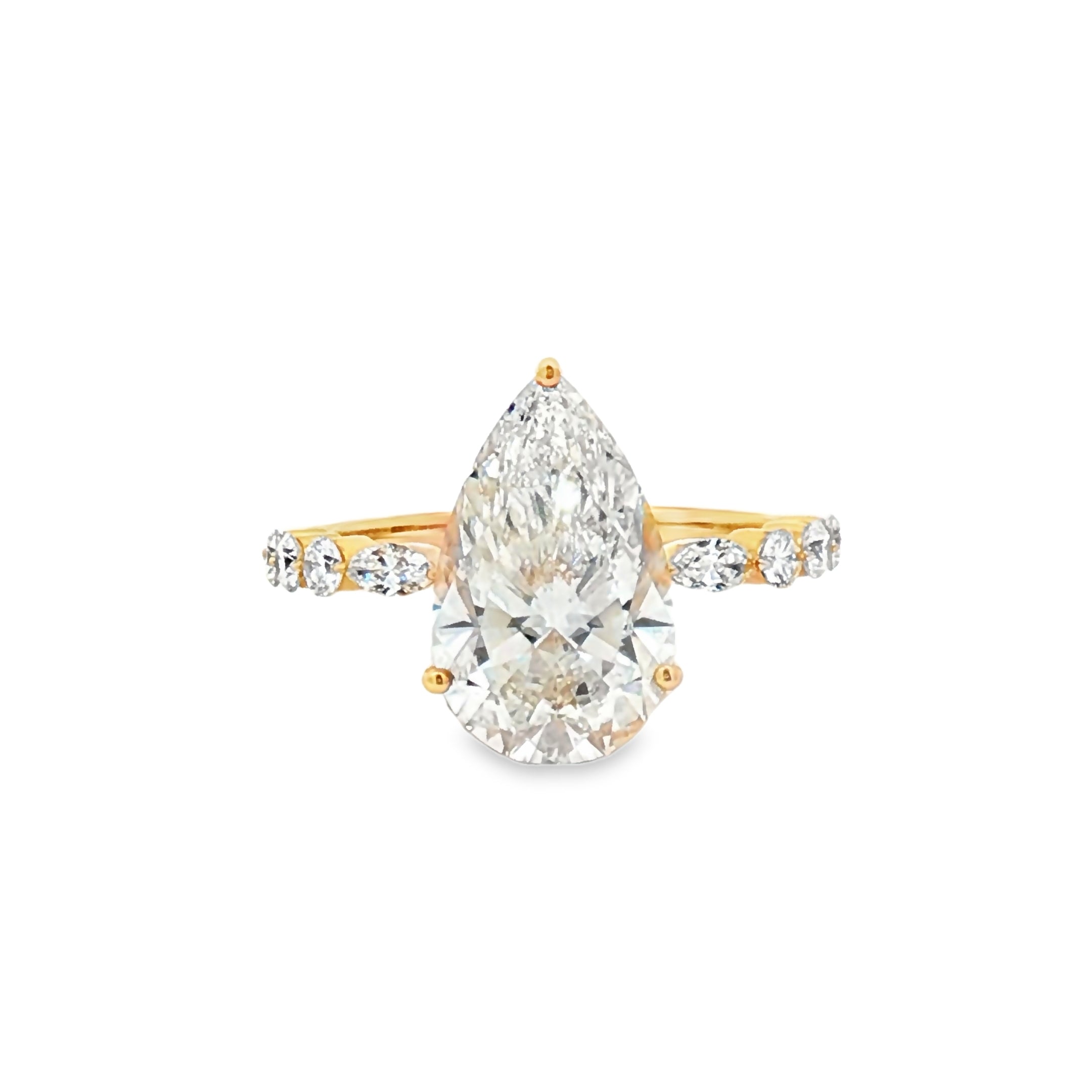alt="front view of lab grown pear cut diamond engagement ring with accent band in 14K yellow gold"