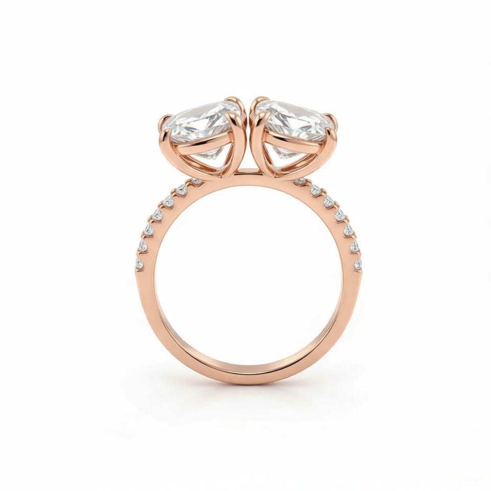 alt="profile view of lab grown pear and emerald cut diamond toi et moi ring in 14K rose gold"
