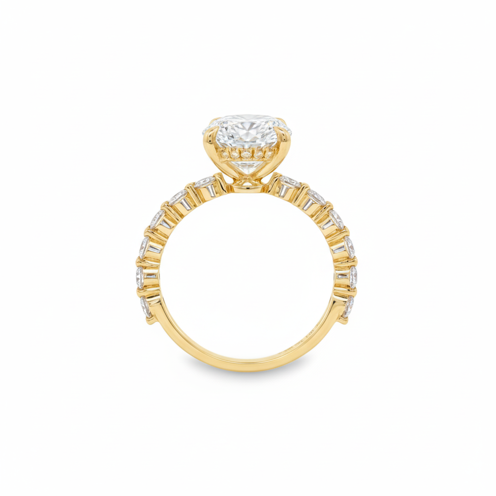alt="profile view of lab grown oval cut diamond engagement ring with accented band in 14K yellow gold"