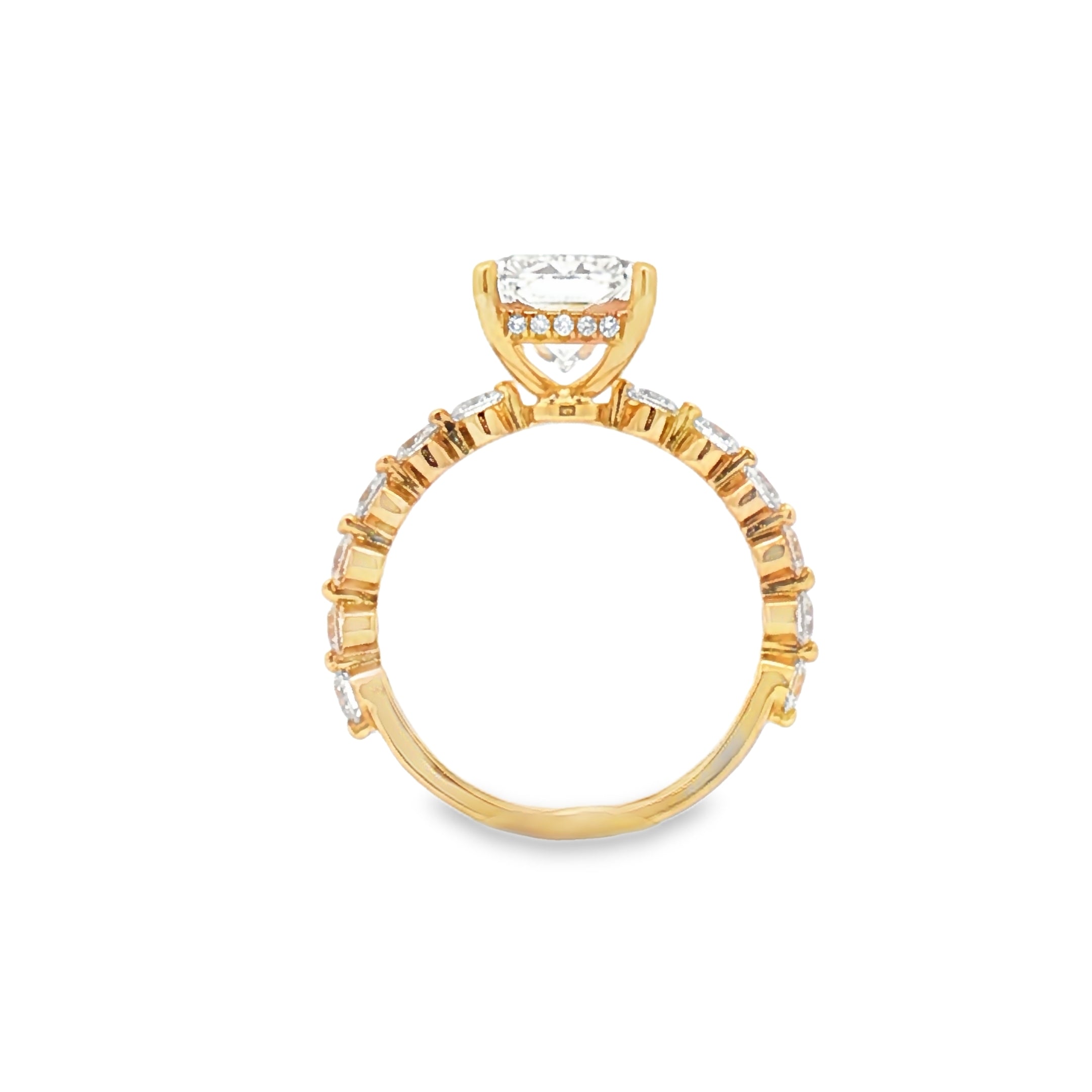 alt="profile view of lab grown radiant cut diamond engagement ring with accented band and hidden halo in 14K yellow gold"