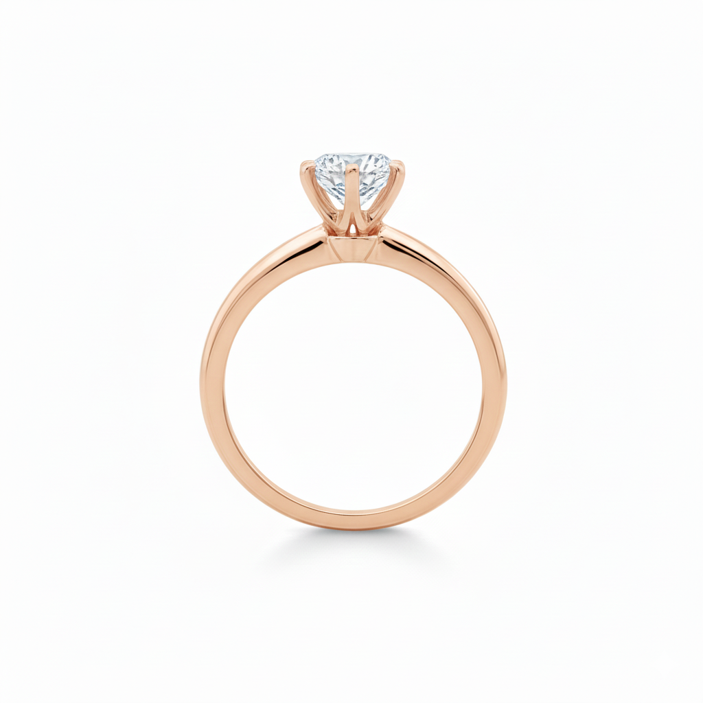 alt="profile view of lab grown round cut diamond six prong setting solitaire engagement ring in 14K rose gold"