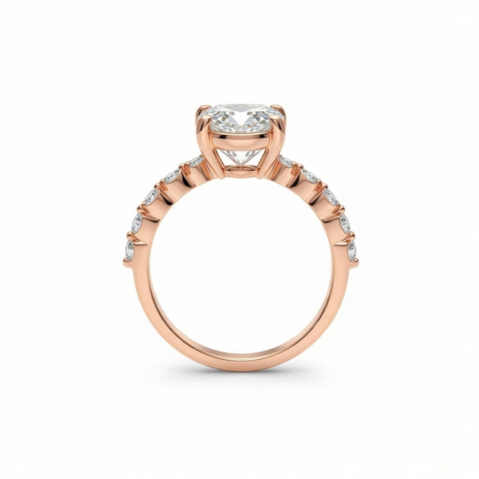 alt="profile view of lab grown pear cut diamond engagement ring with accent band in 14K rose gold"