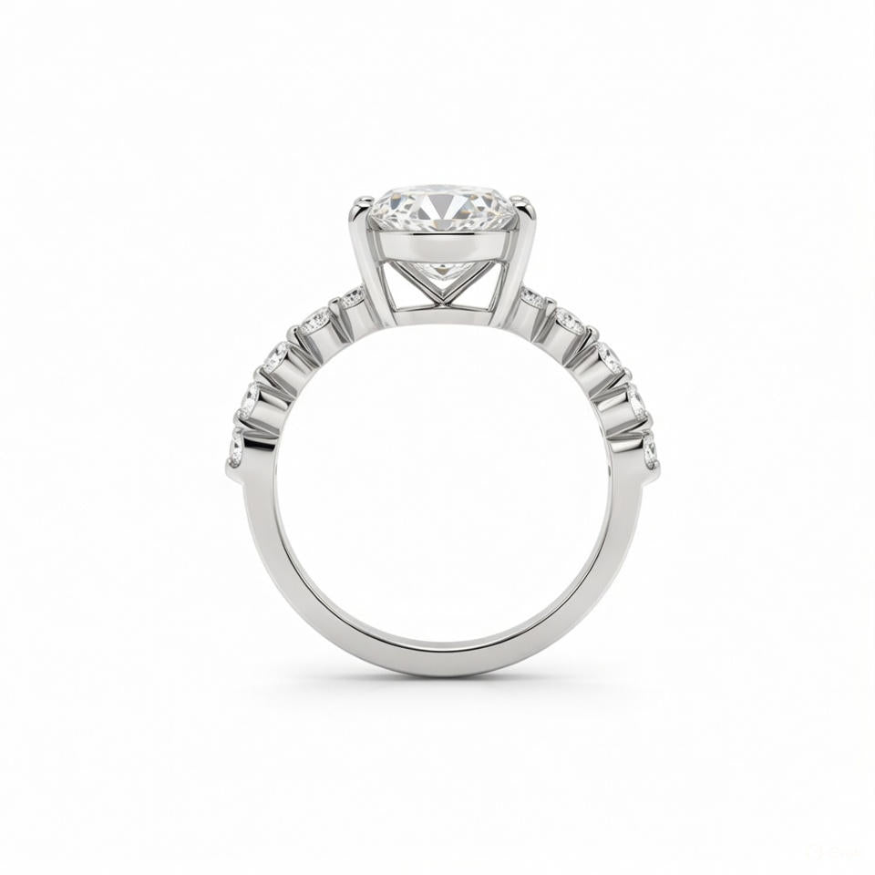alt="profile view of lab grown pear cut diamond engagement ring with accent band in 14K white gold"