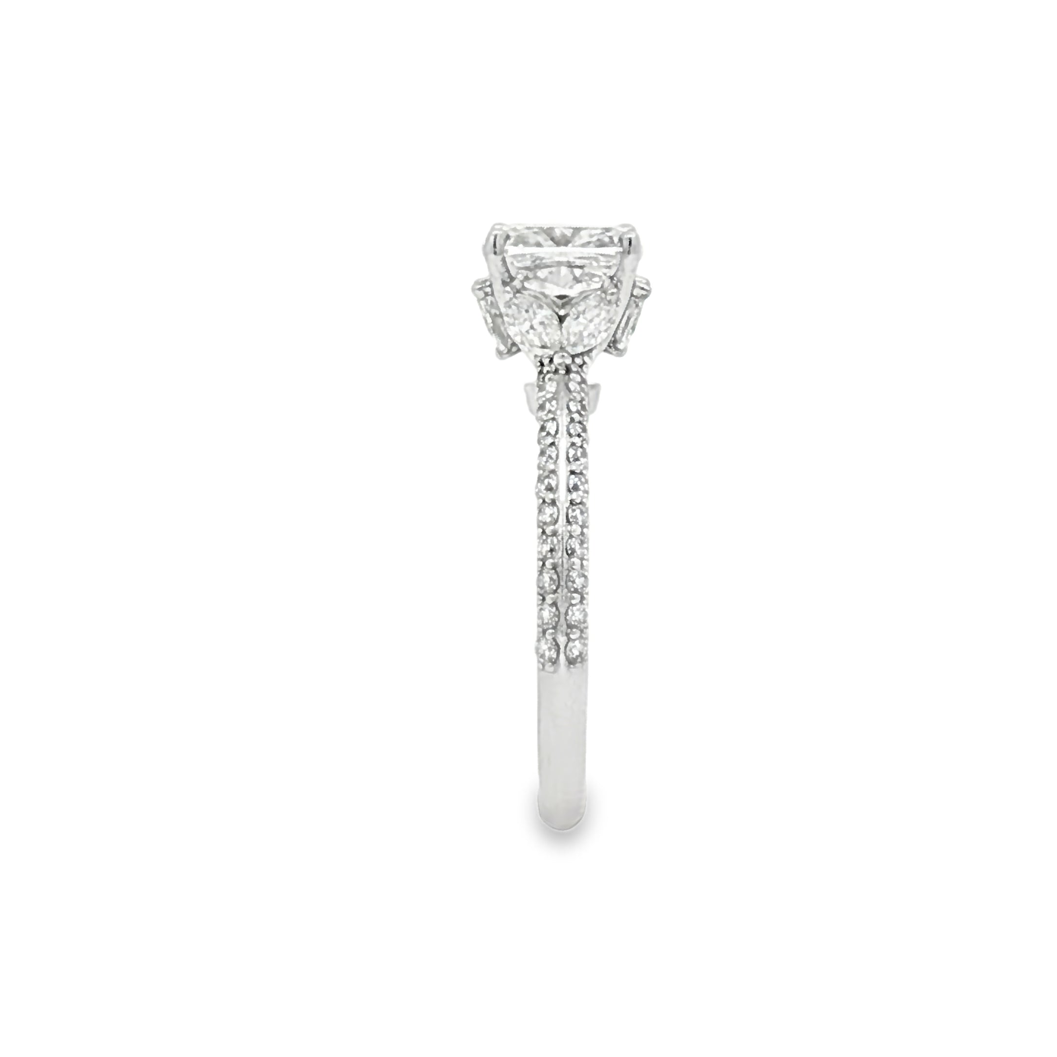 alt="side view of lab grown cushion cut diamond engagement ring with marquise hidden halo and accented band in 14K white gold"