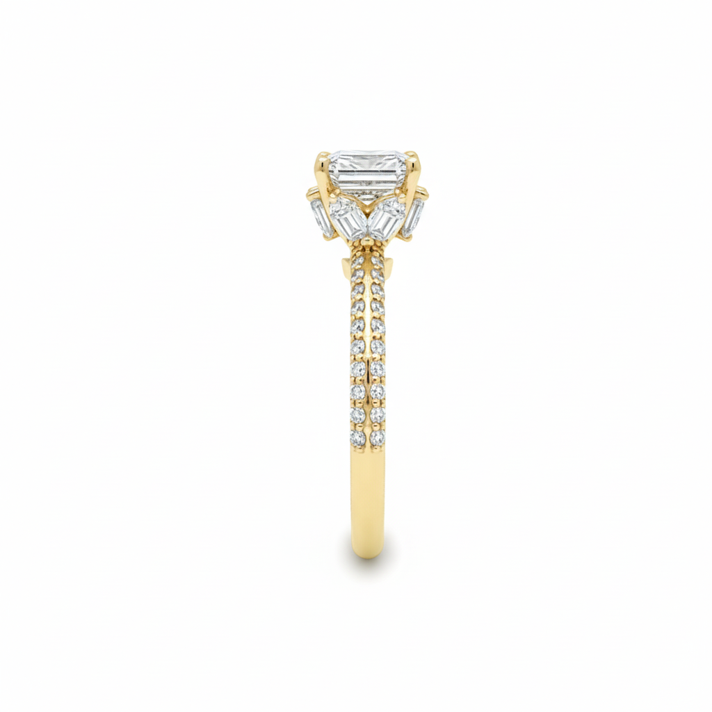 alt="side view of lab grown cushion cut diamond engagement ring with marquise hidden halo and accented band in 14K yellow gold"