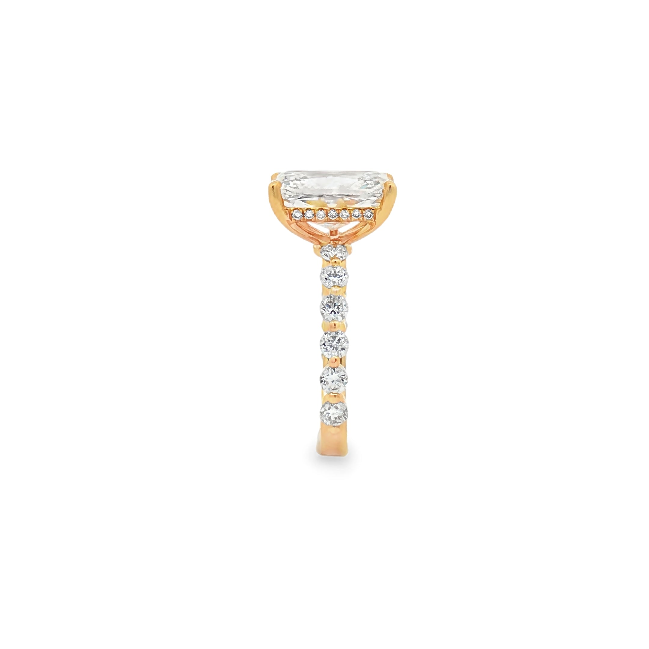 alt="side view of lab grown radiant cut diamond engagement ring with accented band and hidden halo in 14K yellow gold"