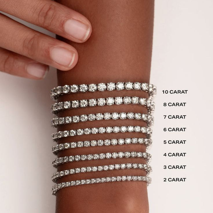 alt="classic four prong round lab grown diamond tennis bracelet carat size guide in 14K white gold"