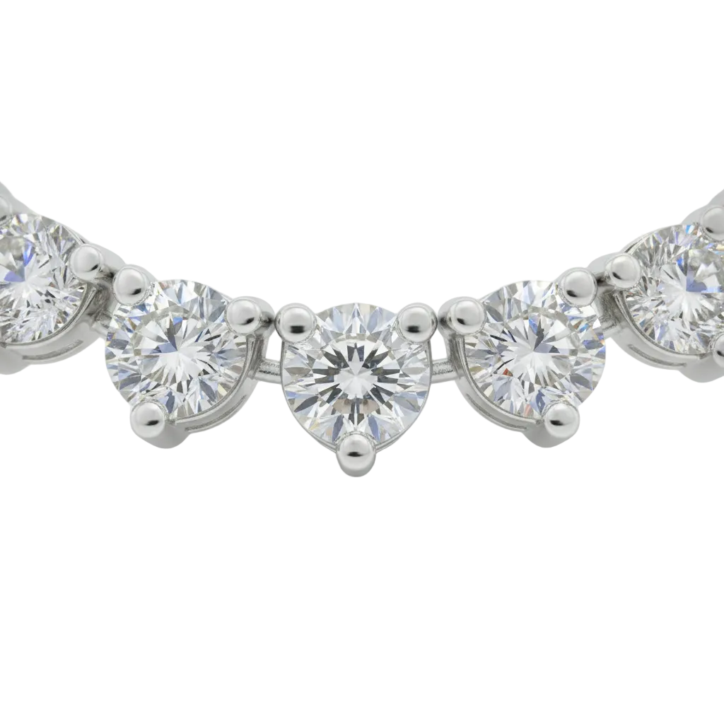 alt="close up of classic three prong round lab grown diamond tennis necklace in 14K white gold"