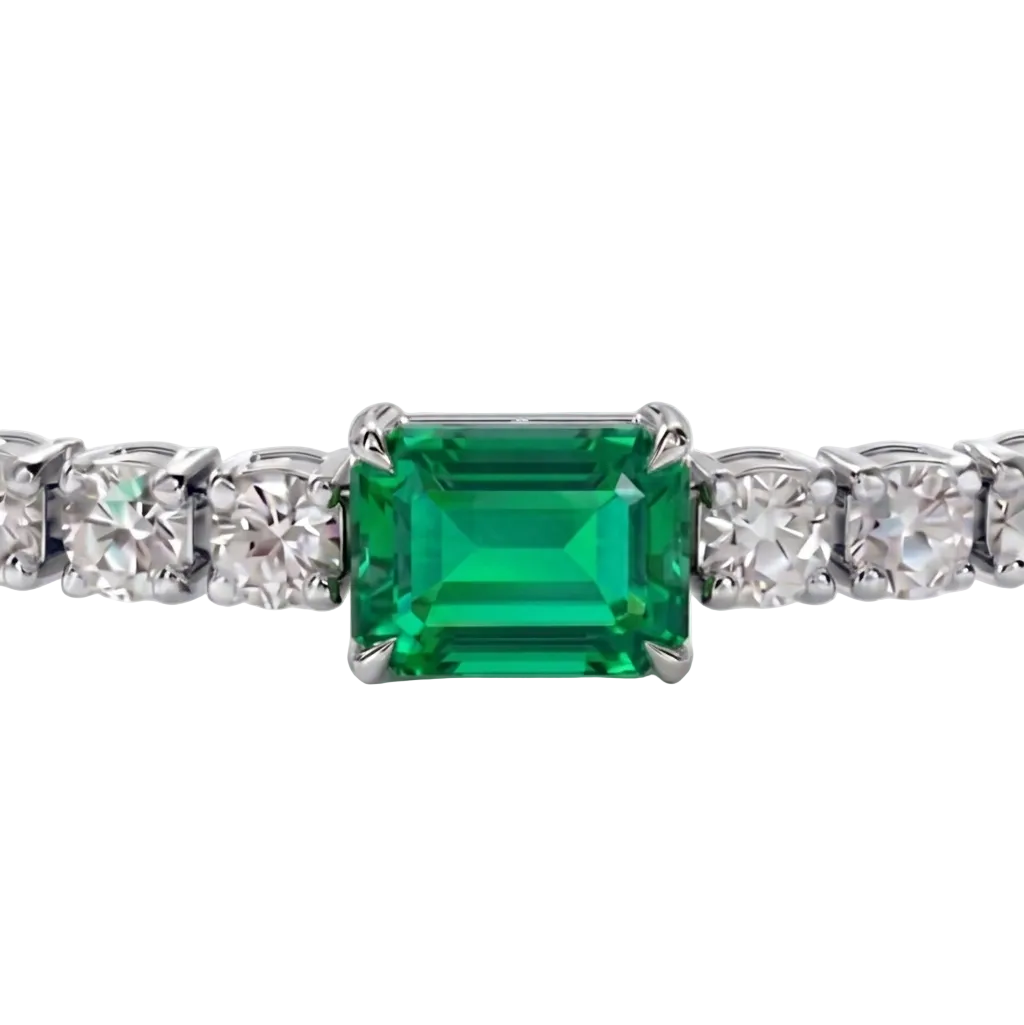 alt="close up view of lab grown emerald cut columbian emerald and round diamond east-west tennis bracelet in 14k white gold"