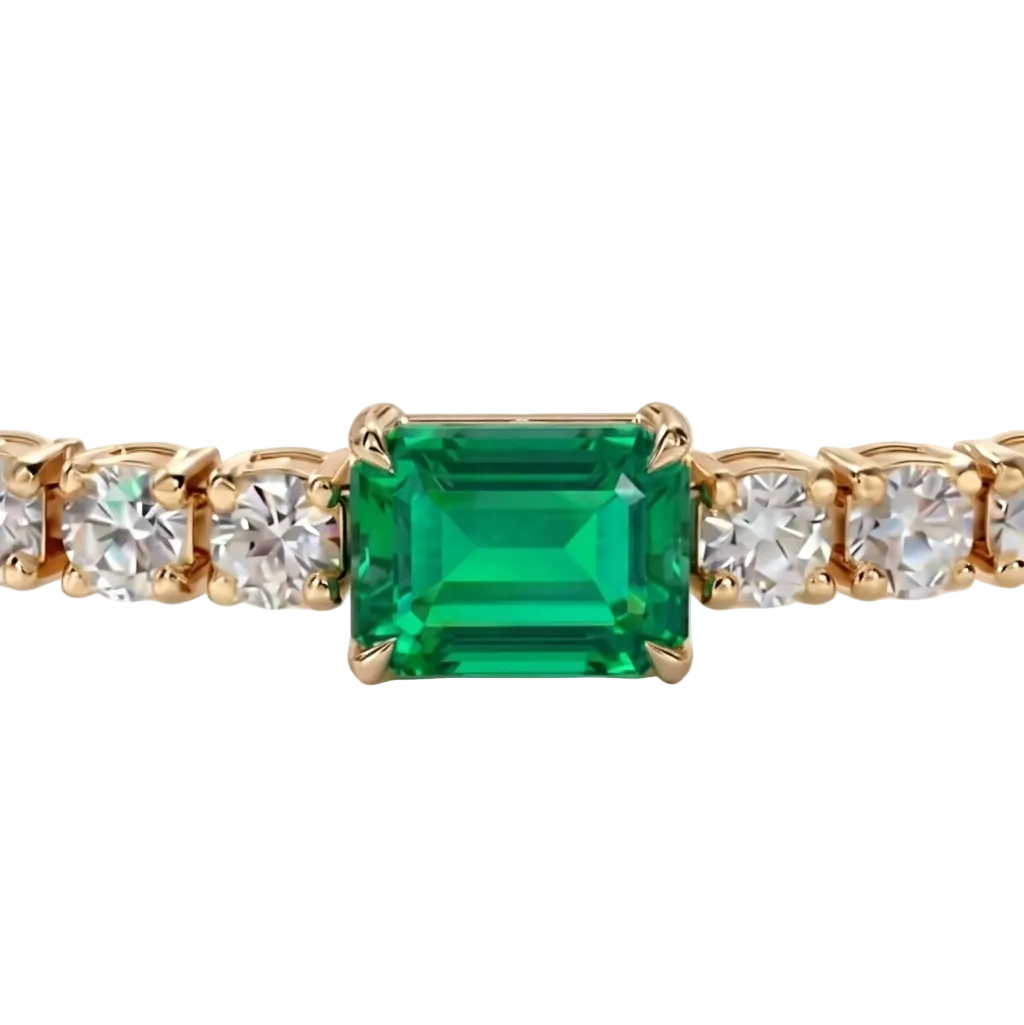 alt="close up view of lab grown emerald cut columbian emerald and round diamond east-west tennis bracelet in 14k yellow gold"