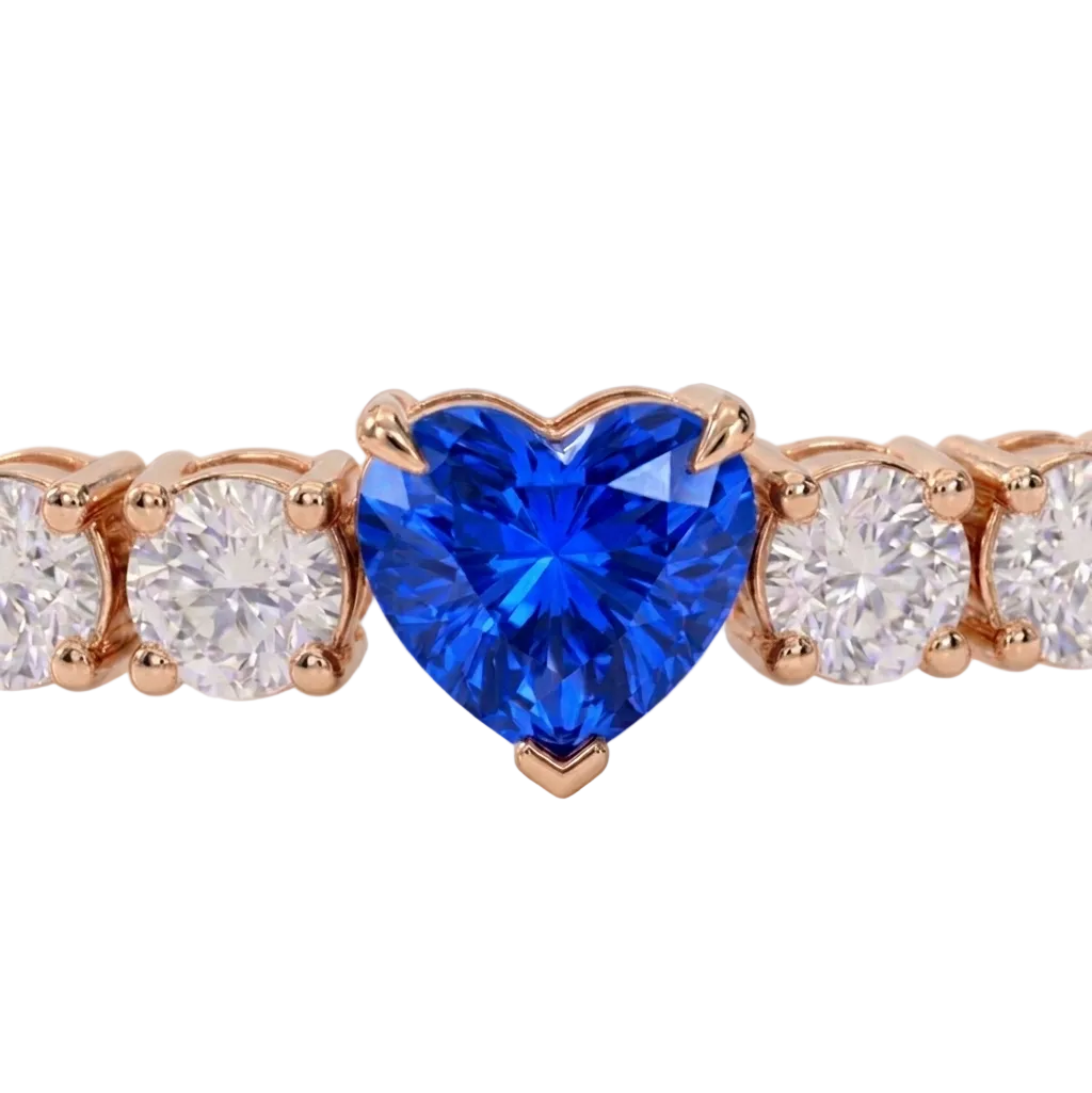 alt="close up view of lab grown heart cut blue sapphire and round diamond east-west tennis bracelet in 14k rose gold"