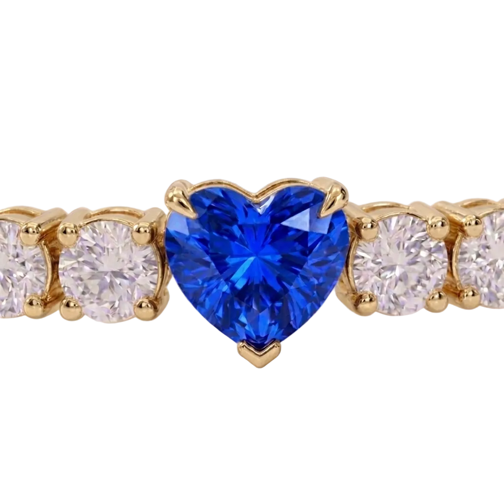 alt="close up view of lab grown heart cut blue sapphire and round diamond east-west tennis bracelet in 14k yellow gold"