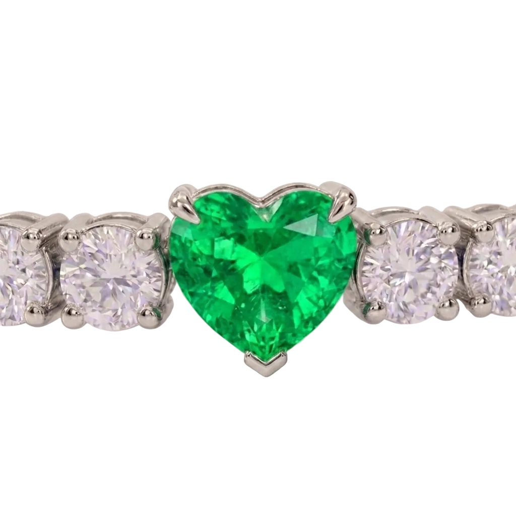 alt="close up view of lab grown heart cut columbian emerald and round diamond east-west tennis bracelet in 14k white gold"
