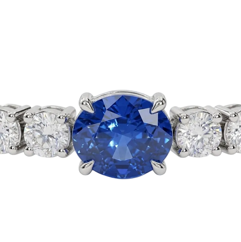 alt="close up view of lab grown oval blue sapphire and round diamond east-west tennis bracelet in 14k white gold"