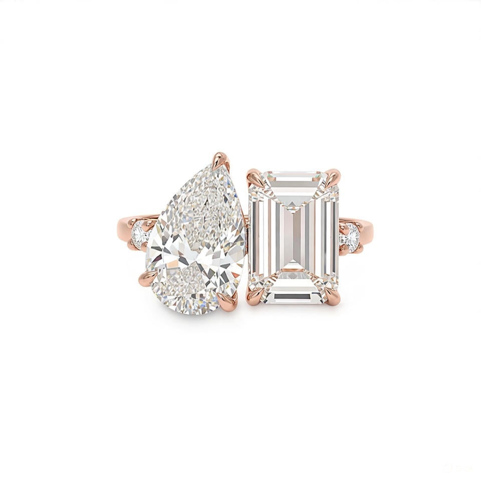 alt="front view of lab grown pear and emerald cut diamond toi et moi ring in 14K rose gold"