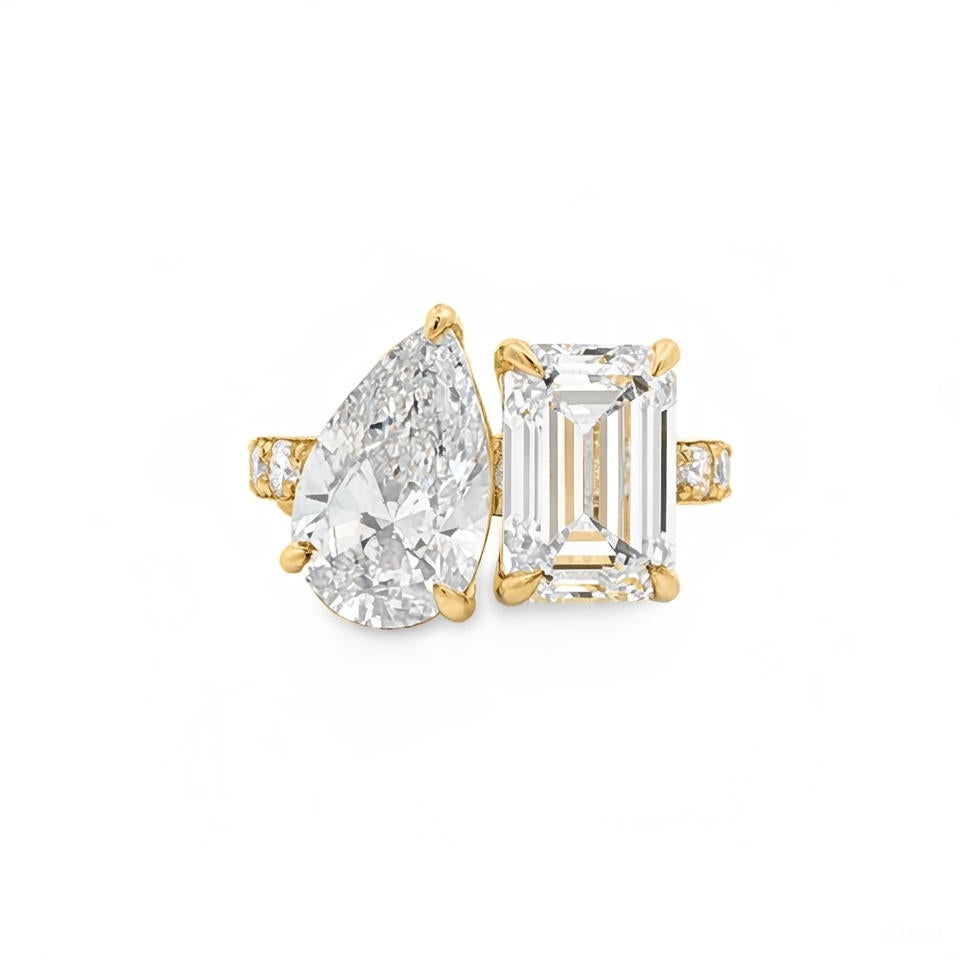 alt="front view of lab grown pear and emerald cut diamond toi et moi ring in 14K yellow gold"