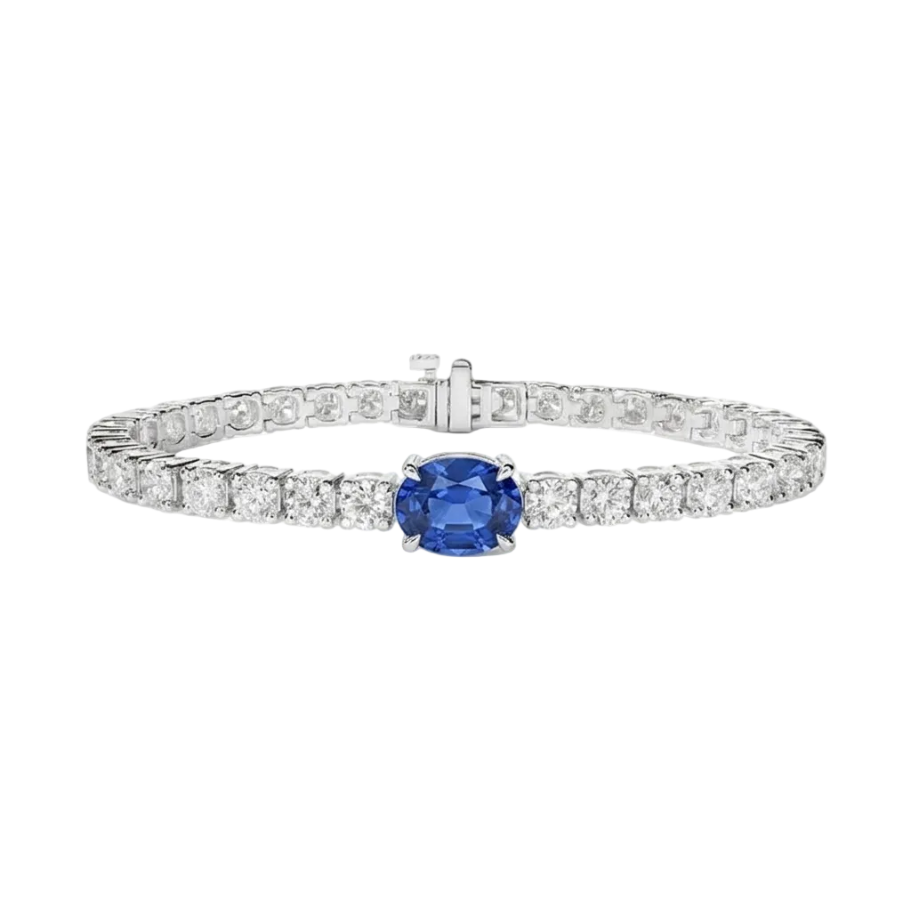 alt="front view of lab grown oval blue sapphire and round diamond east-west tennis bracelet in 14k white gold"