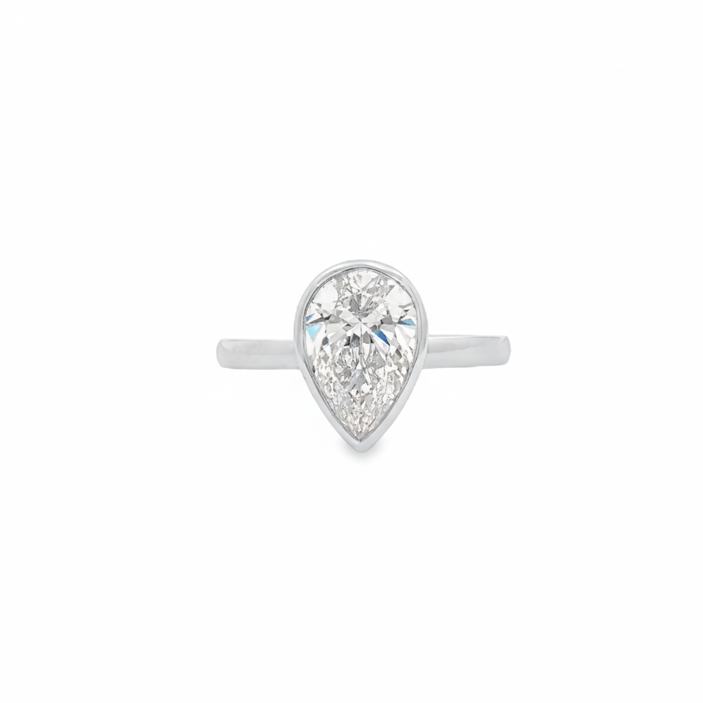 alt="front view of lab grown pear cut diamond bezel set engagement ring in 14K white gold"