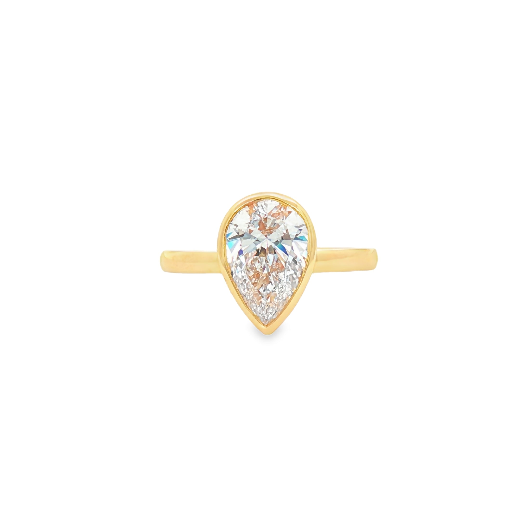 alt="front view of lab grown pear cut diamond bezel set engagement ring in 14K yellow gold"