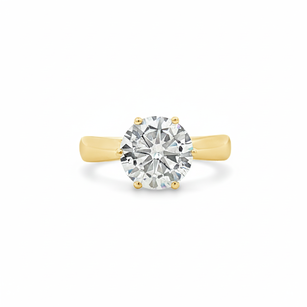 alt="front view of lab grown round cut diamond four prong setting solitaire engagement ring in 14K yellow gold"
