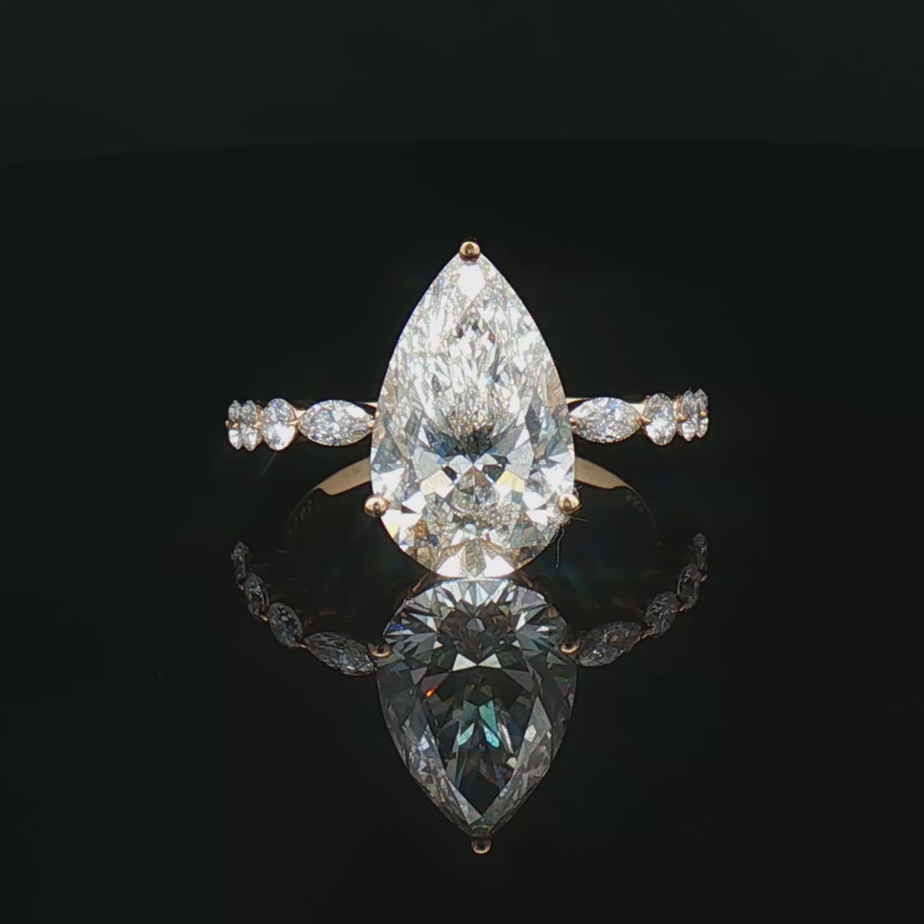 alt="360 video of lab grown pear cut diamond engagement ring with accent band in 14K white gold"