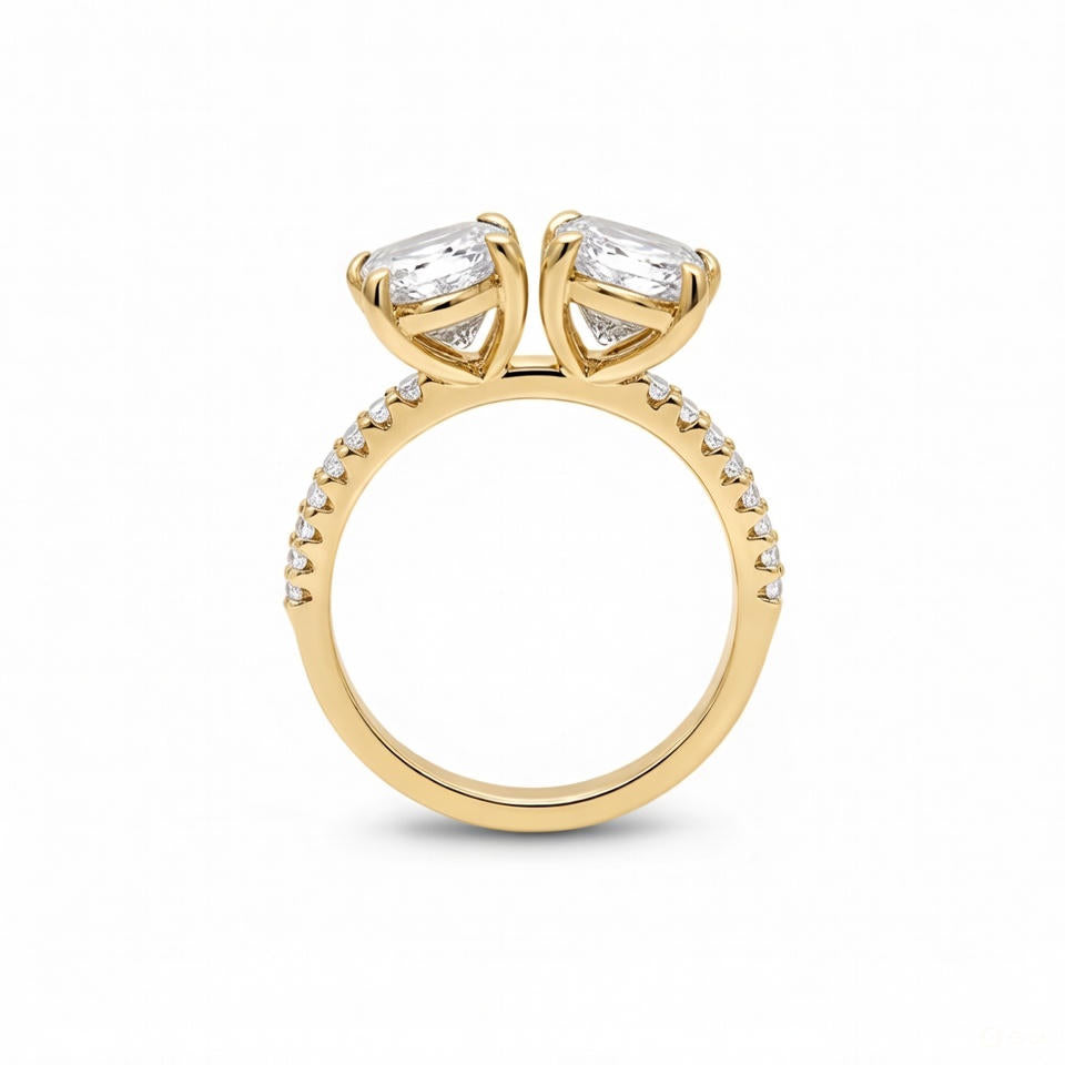 alt="profile view of lab grown pear and emerald cut diamond toi et moi ring in 14K yellow gold"