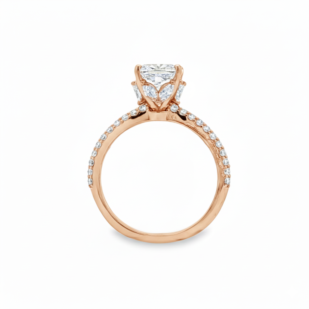 alt="profile view of lab grown cushion cut diamond engagement ring with marquise hidden halo and accented band in 14K rose gold"