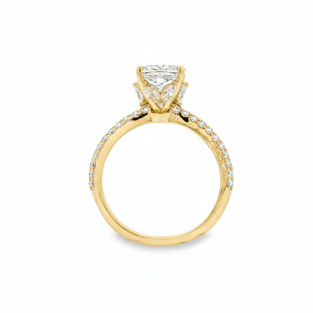 alt="profile view of lab grown cushion cut diamond engagement ring with marquise hidden halo and accented band in 14K yellow gold"