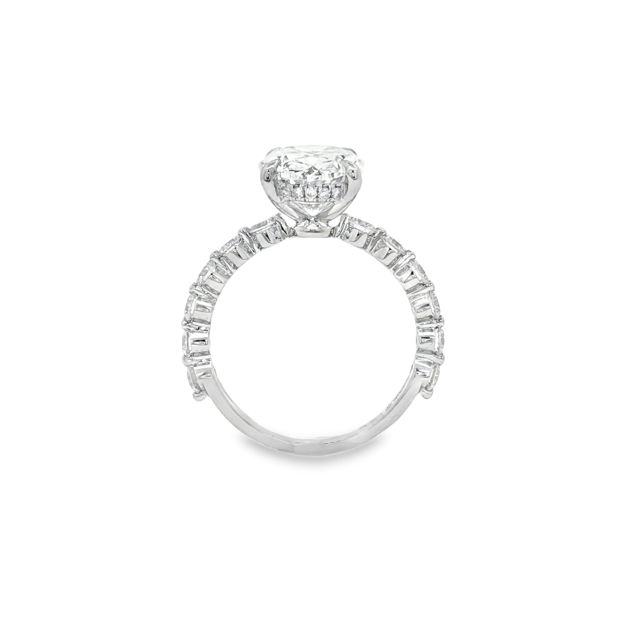 alt="profile view of lab grown oval cut diamond engagement ring with accented band in 14K white gold"