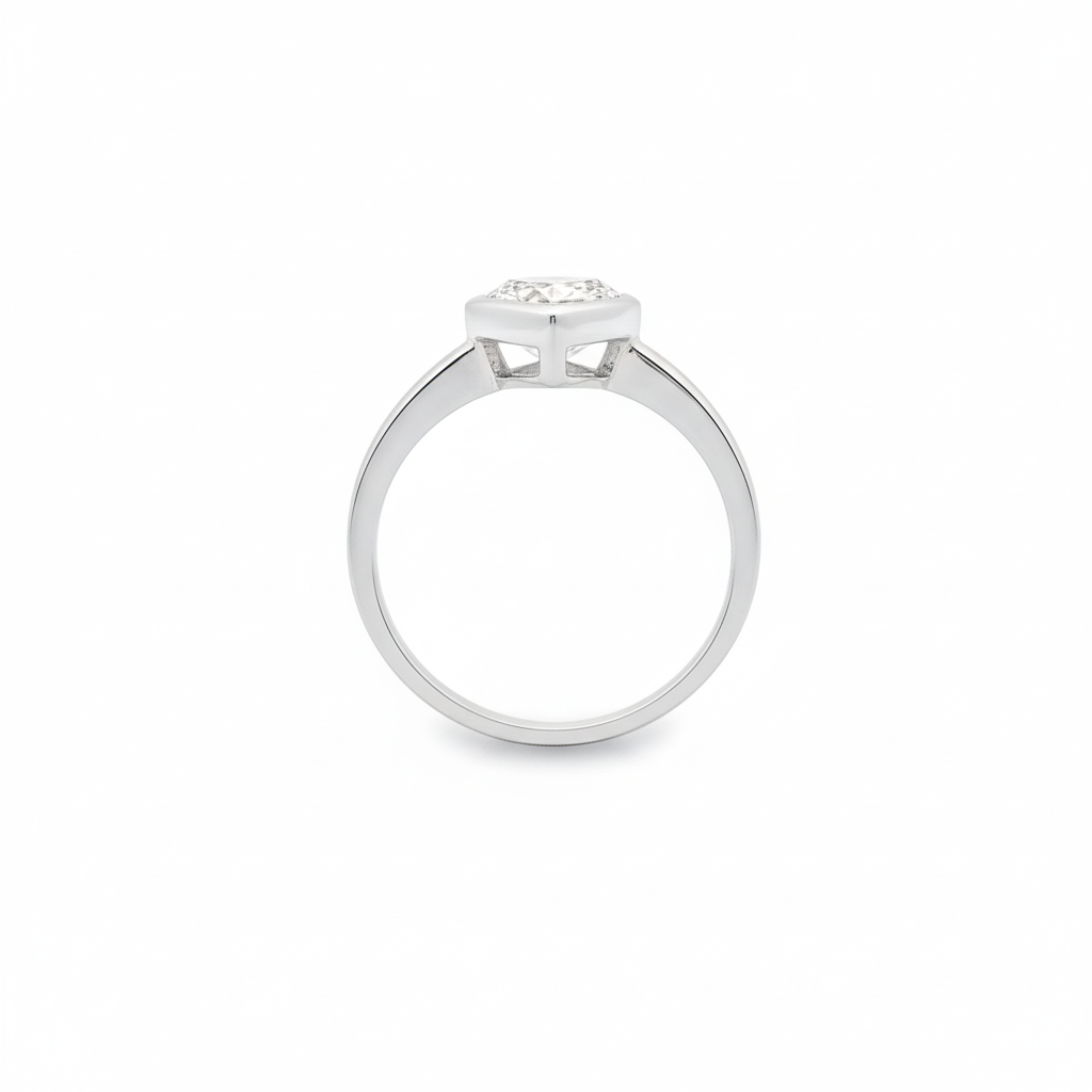 alt="profile view of lab grown pear cut diamond bezel set engagement ring in 14K white gold"