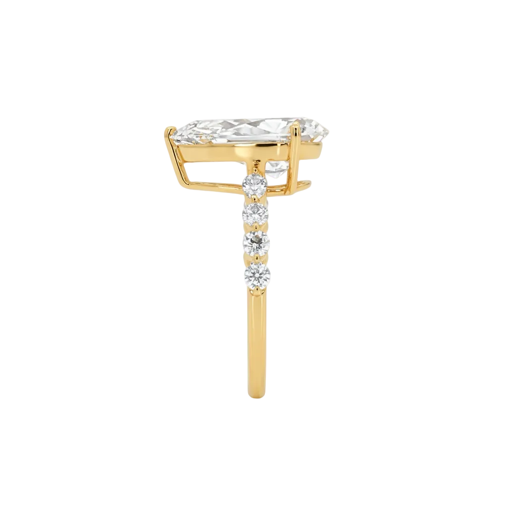 alt="side view lab grown diamond pear cut ring 14K yellow gold"