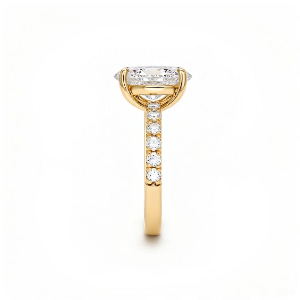 alt="side view of lab grown pear and emerald cut diamond toi et moi ring in 14K yellow gold"