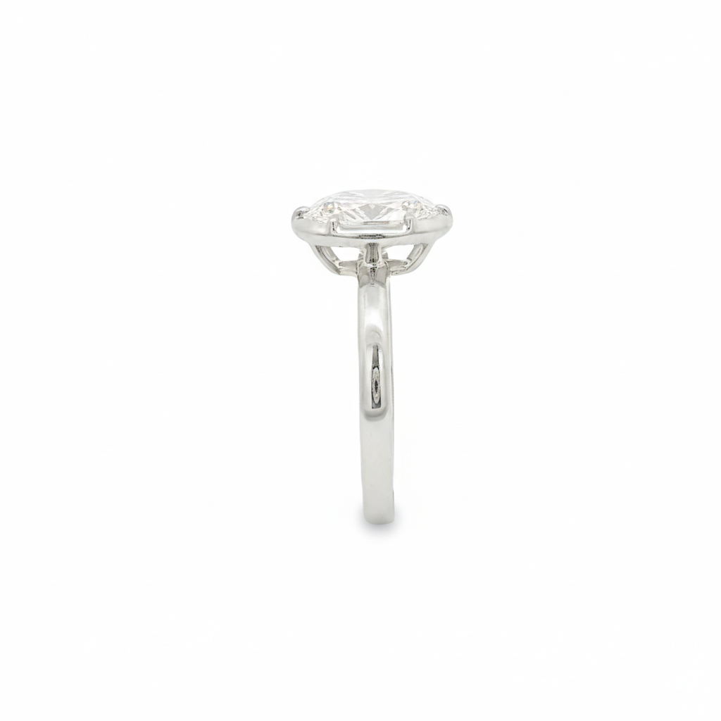 alt="side view of lab grown oval cut diamond bezel set engagement ring in 14K white gold"