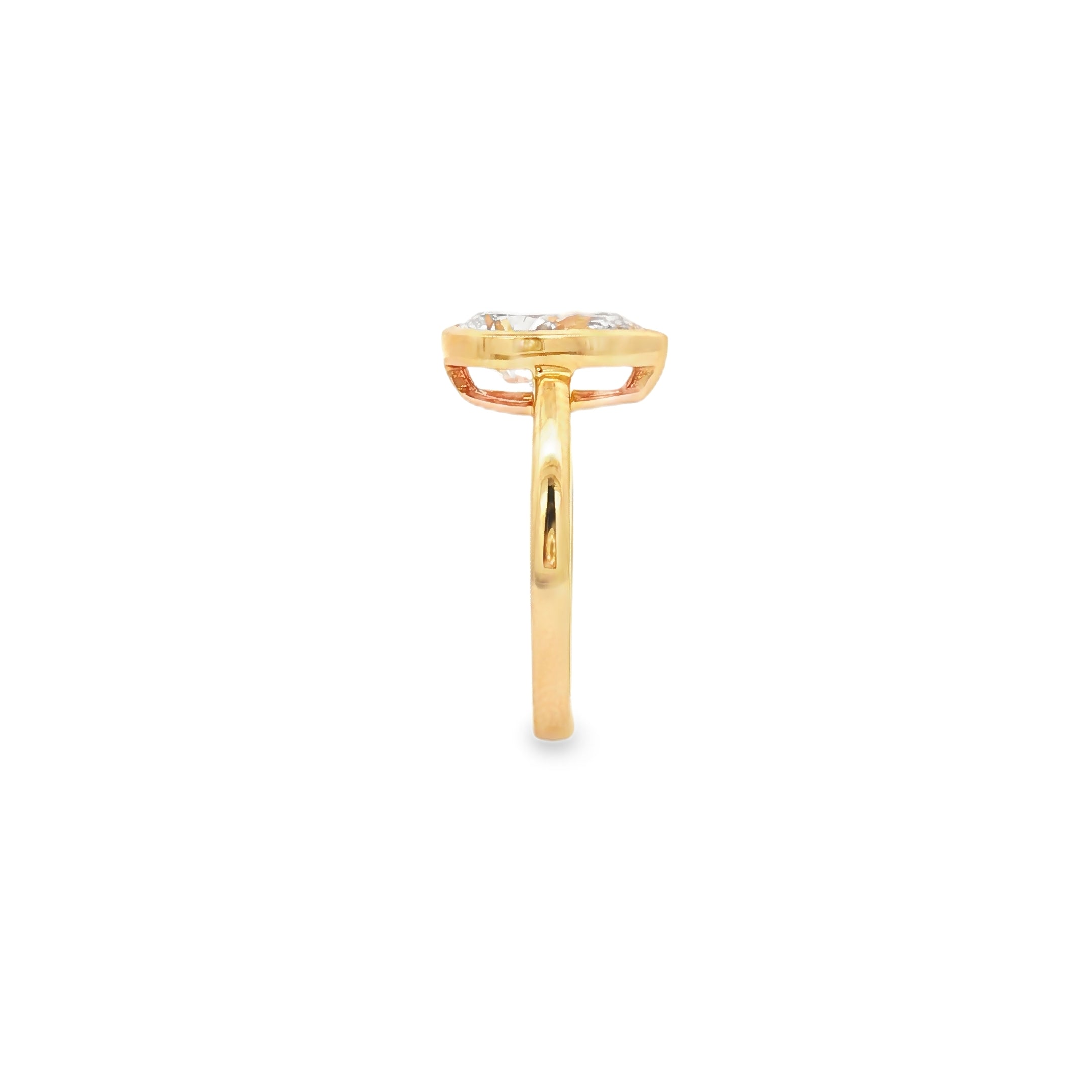 alt="side view of lab grown pear cut diamond bezel set engagement ring in 14K yellow gold"
